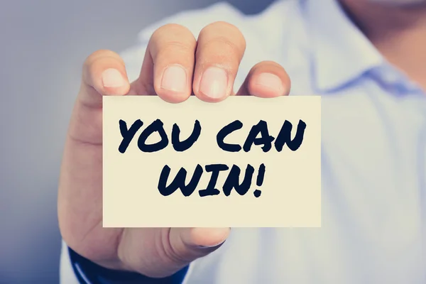 YOU CAN WIN !, message on the card held by a man hand — Stockfoto