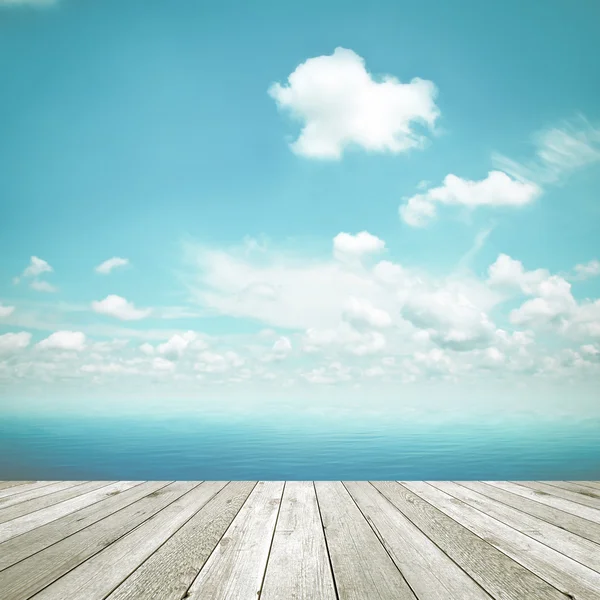 Wood table top on blue sea and sky background, vintage tone image — Stock Photo, Image