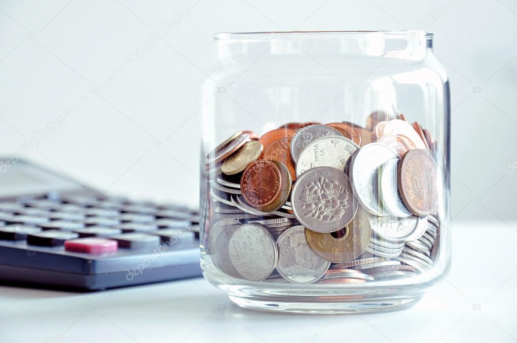 Coins in the glass jar (mixed Asian currencies) 