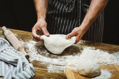 Hands of a chef making pizza dough