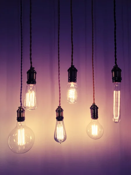 Industrial style light bulbs on purple background — Stock Photo, Image