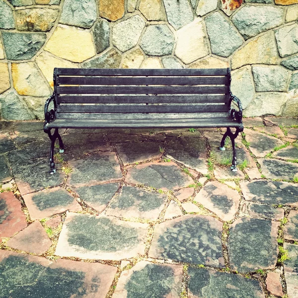 Wooden bench on colorful tile background — Stock Photo, Image