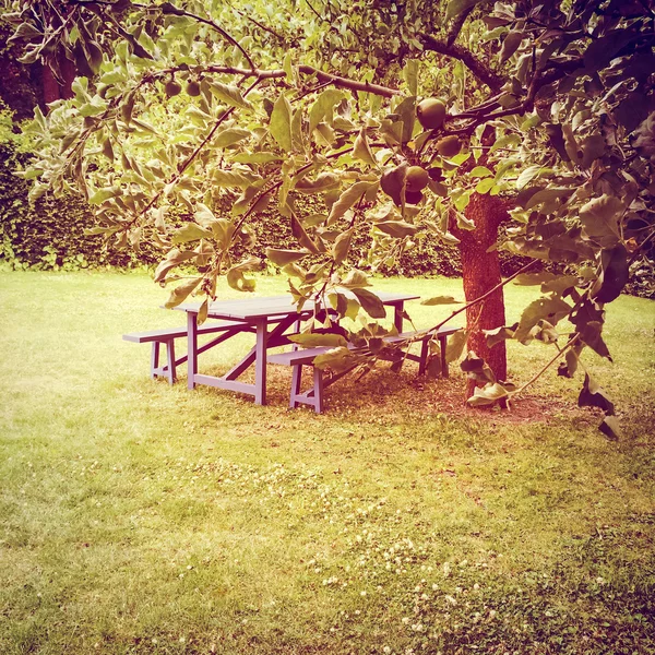 Wooden table in summer garden — Stock Photo, Image