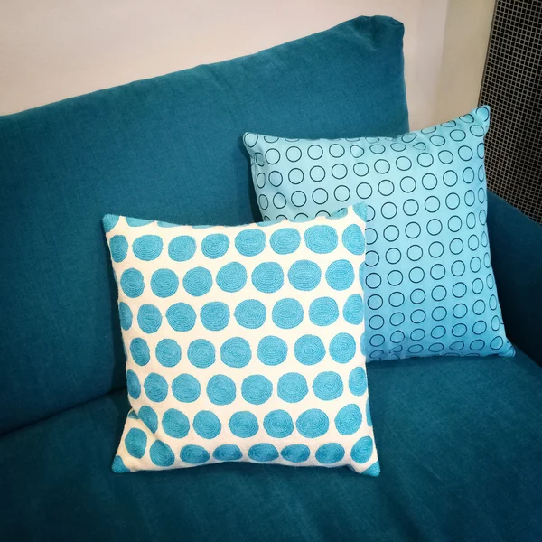 Stylish cushions decorating blue sofa — Stock Photo, Image