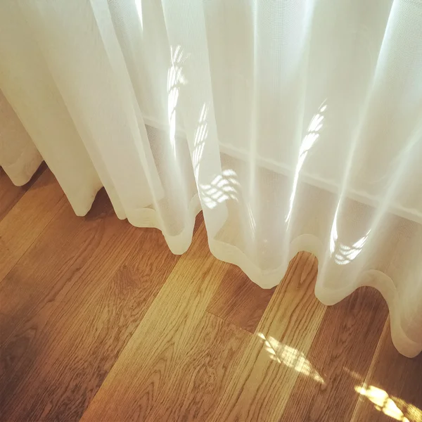 Rideau blanc dans une chambre avec sol en bois — Photo