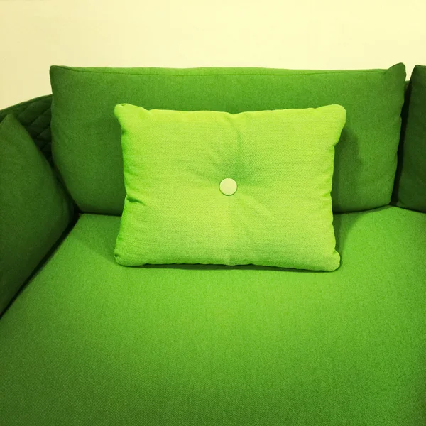 Bright green sofa with cushion — Stock Photo, Image