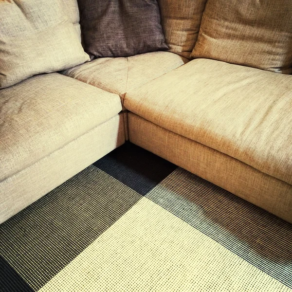 Modern corner sofa and carpet — Stock Photo, Image