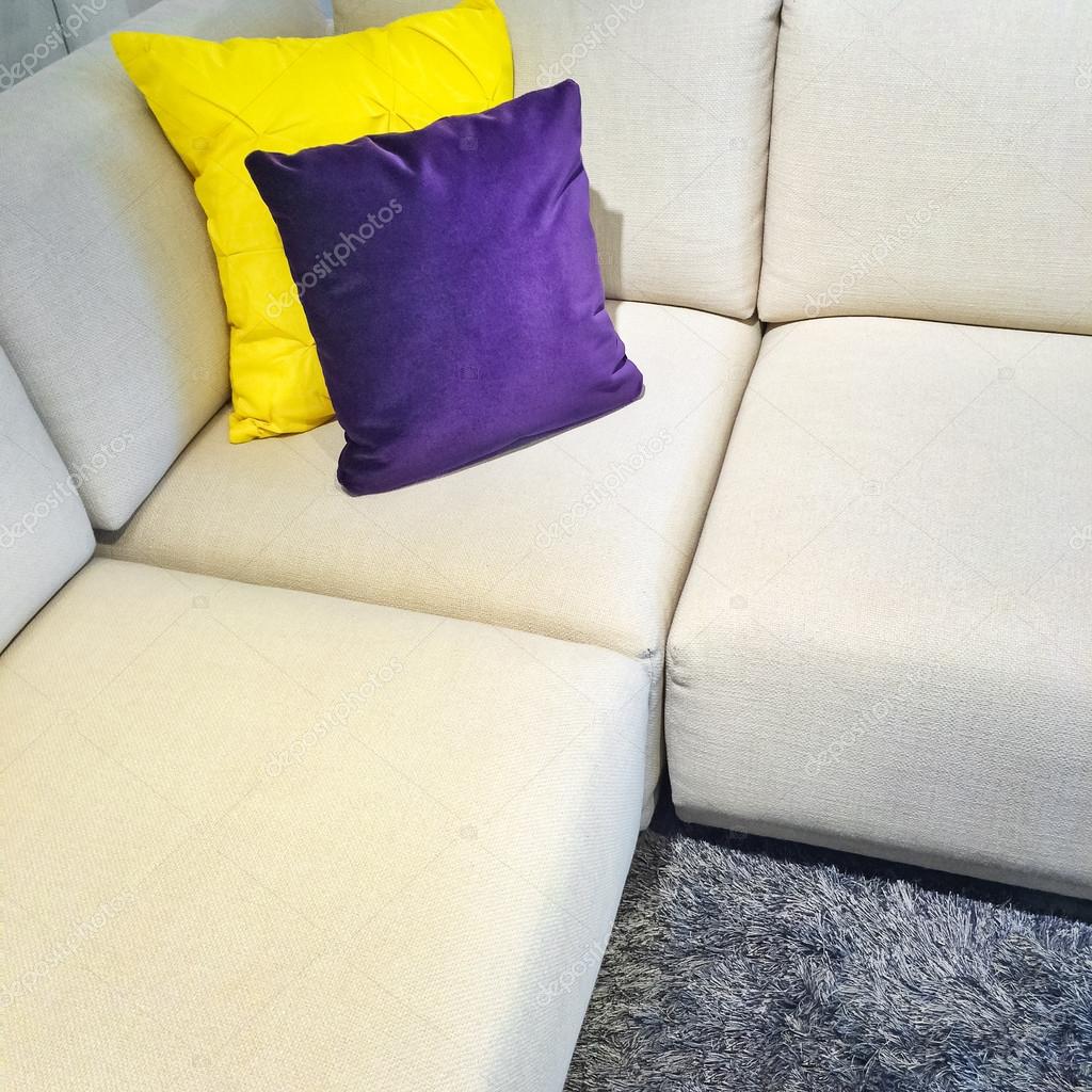 White corner sofa with colorful cushions Stock Photo by