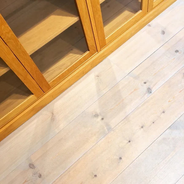 Empty bookcase on wooden floor — Stock Photo, Image