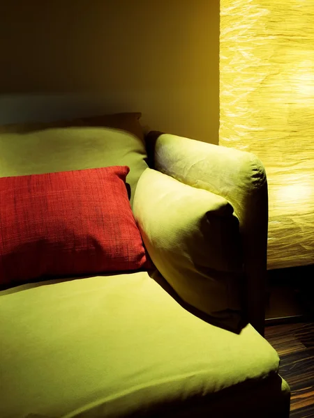 Detail of living room with lamp and green sofa Stock Image