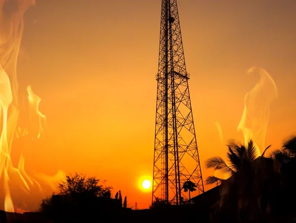 Reception antenna with  orange sky and fire — Stock Photo, Image