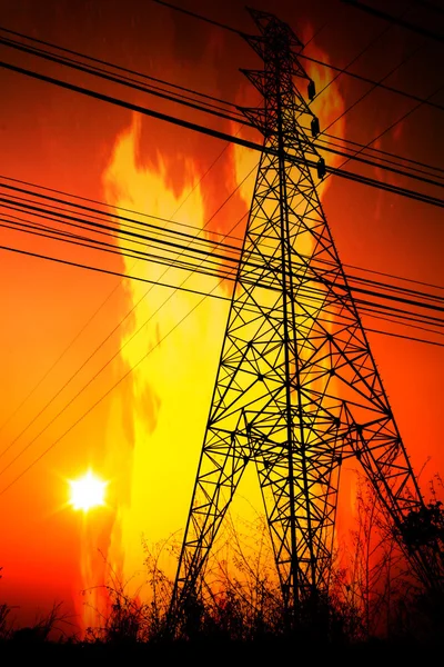 High voltage pole with a flame burning sunset — Stock Photo, Image