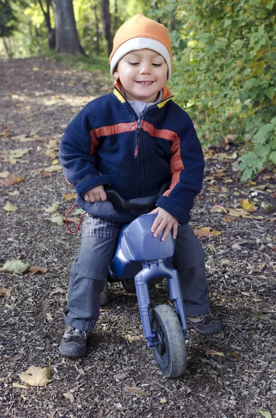 Child on toy bike — 图库照片