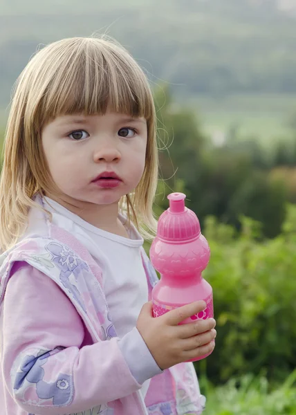 Child with water bottle in nature — Stock Photo, Image