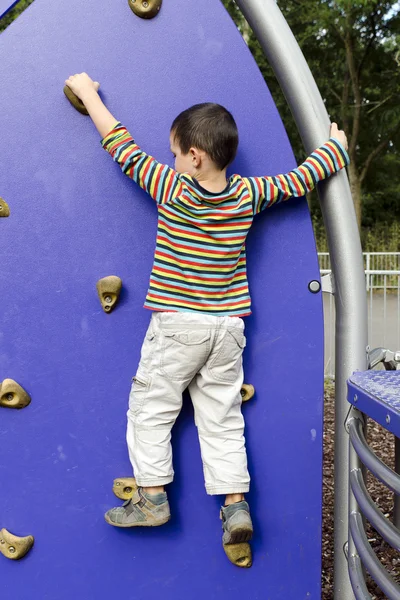 Child climbing at playground — Stock Photo, Image