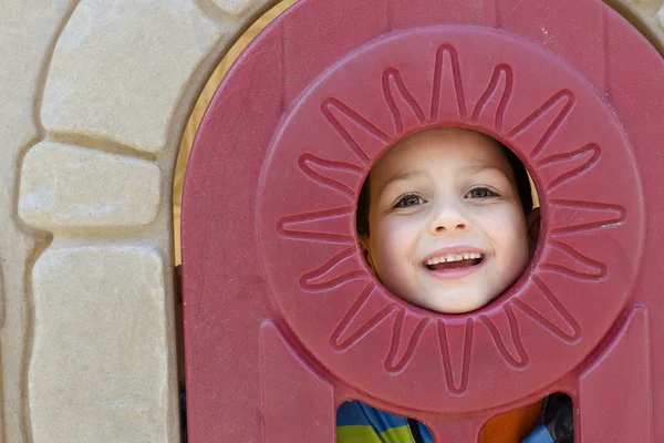 Child in playhouse window — Stock Photo, Image