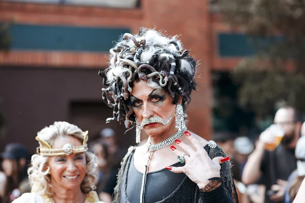 Unidentified people at the annual gay festival Folsom Street Fair in San Francisco, everyone is happy, having fun, and wear Carnival clothing