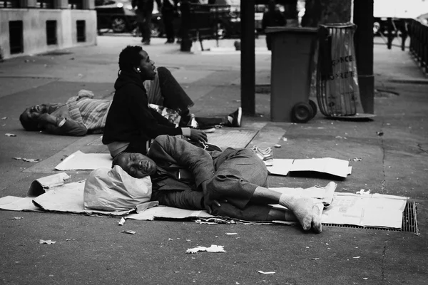 Men sleeping on the street in Paris. Homelessness in EU reached 3 million people in 2004. Globally about 100 million people live on the street. Black and white.