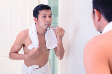 Yakışıklı delikanlı kendini tarafından ayna ile tıraş.