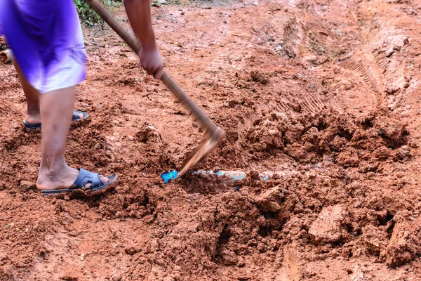 Simple underground pipe installation using hoe. — Stock Image Simple underground pipe installation using hoe. Stock Image