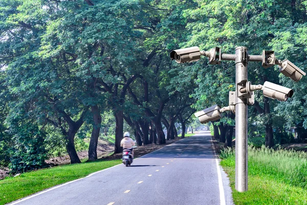 Security camera voor monitring een weg met schaduw van de boom tunnel. — Stockfoto