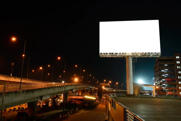 Blank billboard near express way at night for advertisement.