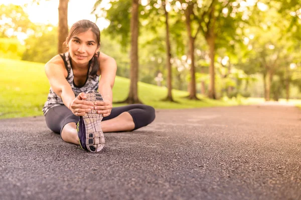 Front view of woman runner stretching warm up before running, focus on shoe. — Stock Photo, Image