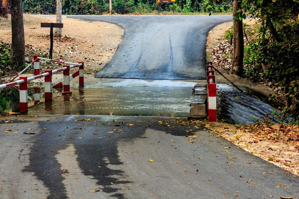 Flooding over the road at national park waterfall. — Stock Photo, Image