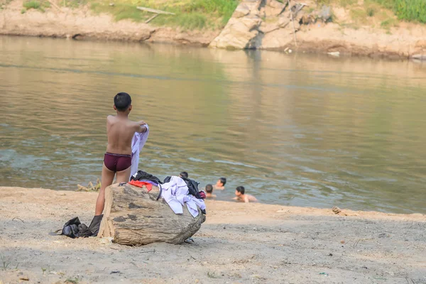 Boy wearing white shirt  after swimming in river with his friend — Stock Photo, Image