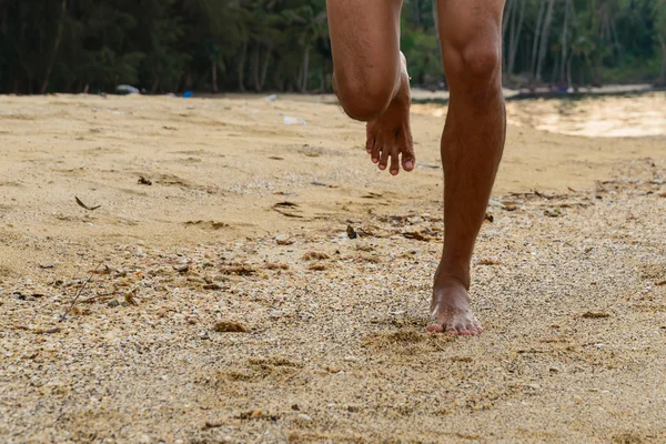 Barefoot running on beach at sunset. — Stock Photo, Image