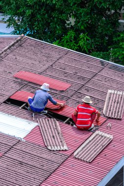 Adam işçiler yerine eski kiremit çatı zarar.