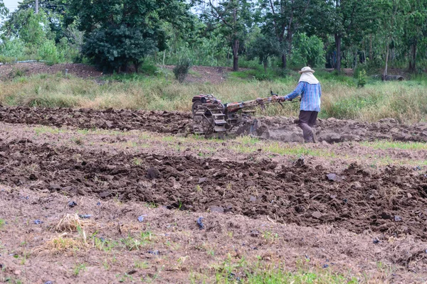 Thai farmer using walking tractors for cultivated soil for prepare plantation. — Stock Photo, Image