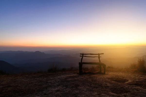 Banco de madeira no pico da montanha com horizonte bonito . — Fotografia de Stock