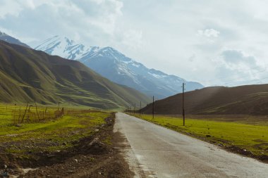 Dağ yolu bomboş. Eko-turizm, kaçamak, yolculuk konsepti. Sakin bir kara parçası. Fotokopi alanı olan fotoğraf. Kafkasya 'nın Manzaralı Görüntüsü, Sinematik Estetik.