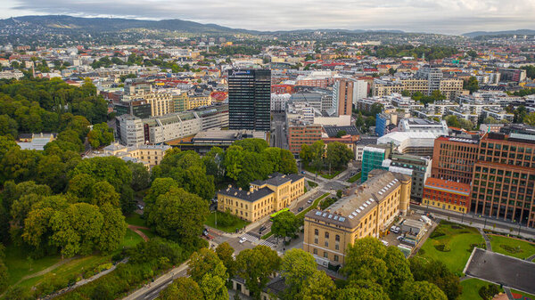 Oslo, Norway. Beautiful panoramic aerial view photo from flying drone for Oslo city center. Against the background of mountains and blue sky on a sunny summer day. (Series)