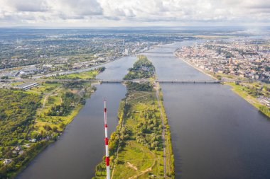 Riga, Latvija. Uçan İHA 'dan Riga Radyo ve Televizyon Kulesi Riga' ya güzel bir panoramik hava görüntüsü. Arka planda Zakusala, Daugava nehri ve Riga şehri güneşli bir yaz gününde. (Seriler)