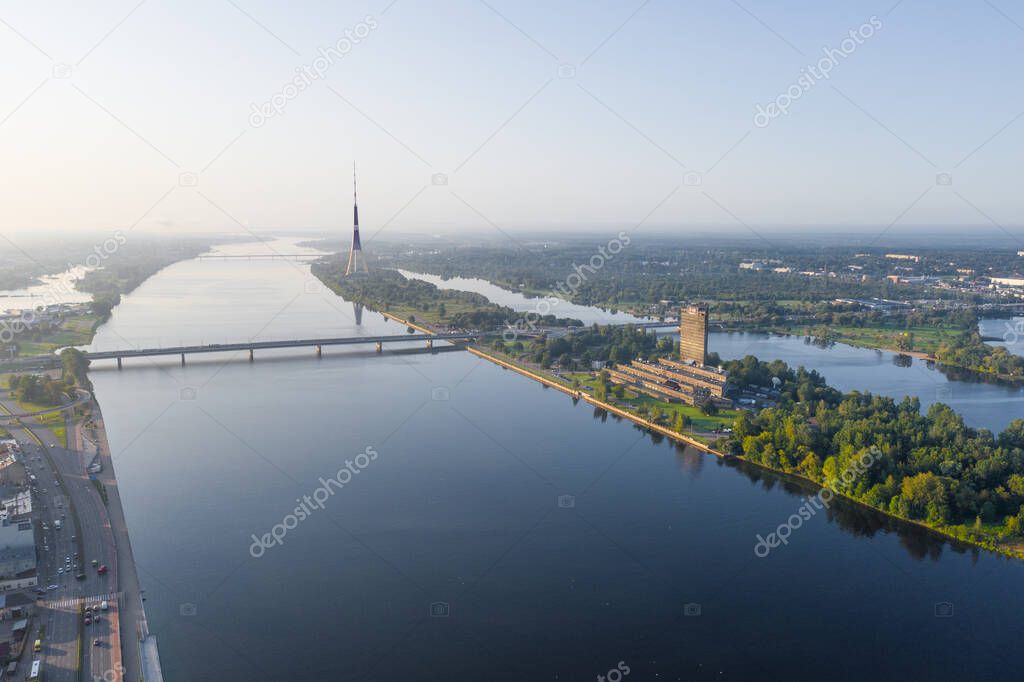 Riga, Latvija. Beautiful panoramic aerial view photo from flying drone to The Riga Radio and TV Tower Riga. In the background zakusala, river Daugava and the city of Riga on a sunny summer day. (Series)