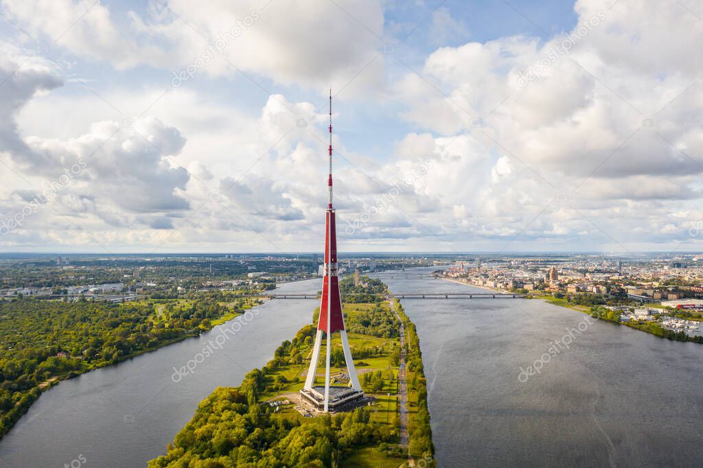 Riga, Latvija. Beautiful panoramic aerial view photo from flying drone to The Riga Radio and TV Tower Riga. In the background zakusala, river Daugava and the city of Riga on a sunny summer day. (Series)