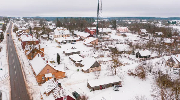 Akniste, Jekabpils, Letonya, Baltık. Kışın insansız hava aracından Akniste şehrine kadar uzanan güzel panoramik hava manzaralı fotoğraf. Küçük kasaba ve ormanlarda kar yağışlı bir kış manzarası. (seri)