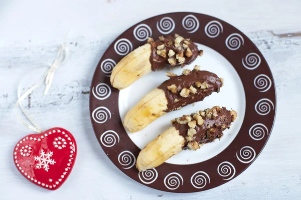 Chocolate dipped bananas with nuts — Stock Photo, Image