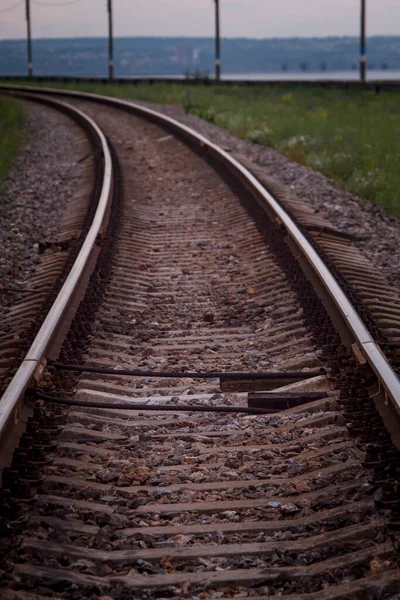 Railway turning left against the background of the embankment