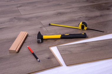 Döşeme, çekiç, çekiç, çekiç, kalem ve metreyi yerleştirmek için ekipman veya araç gereç. Seçici odak.