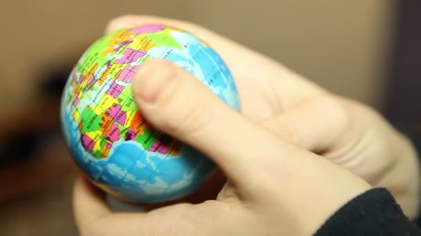 Small globe in the hands of women — Stock Video