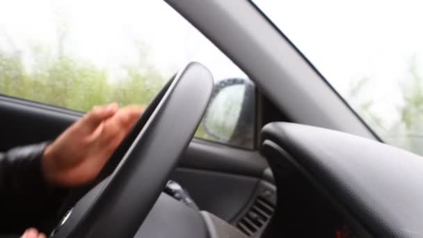 Hand spinning wheel man riding in a car, close-up — Stock Video