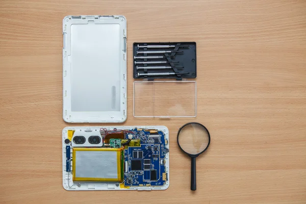 Disassembled tablet and tools on the table. View from above. — Stock Photo, Image