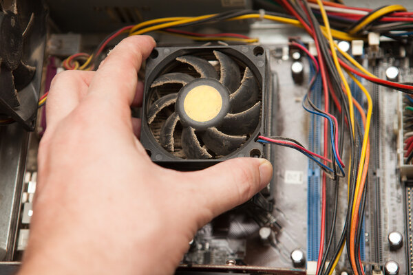 man gets dusty cooler of the system unit.