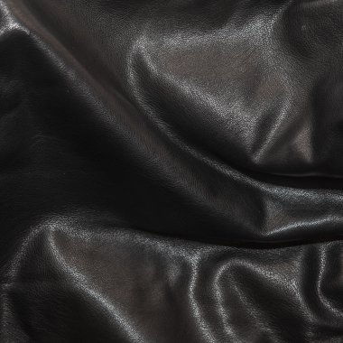 Siyah deri kıvrımları arka planda