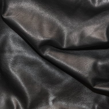 Siyah deri kıvrımları arka planda