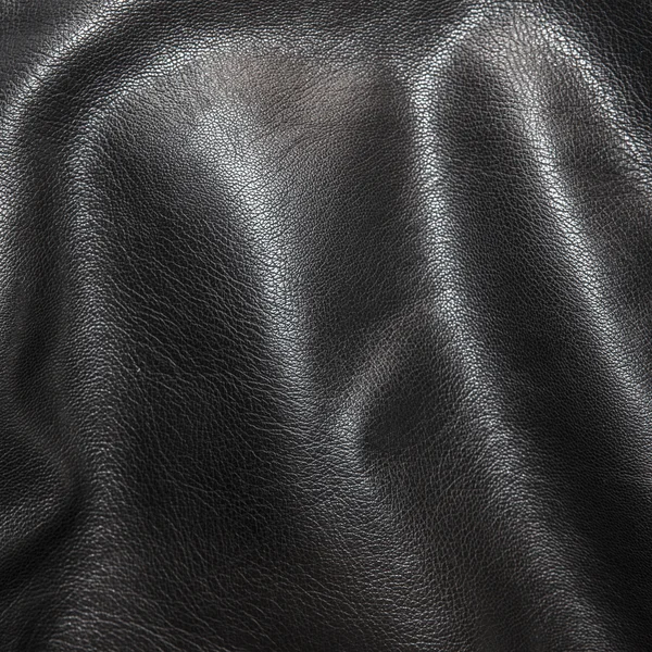 Fondo de cuero negro en los pliegues — Foto de Stock