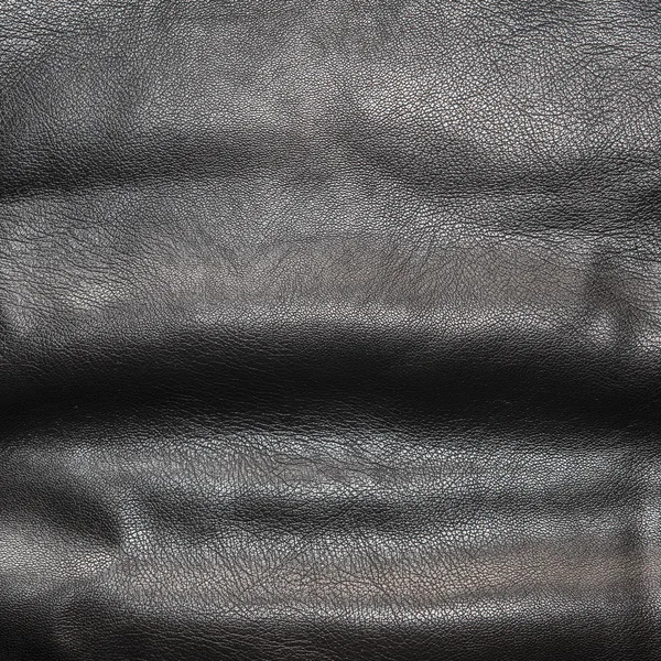 Black leather background in the folds — Stock Photo, Image